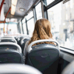 Unha moza sentada dentro de um autocarro.